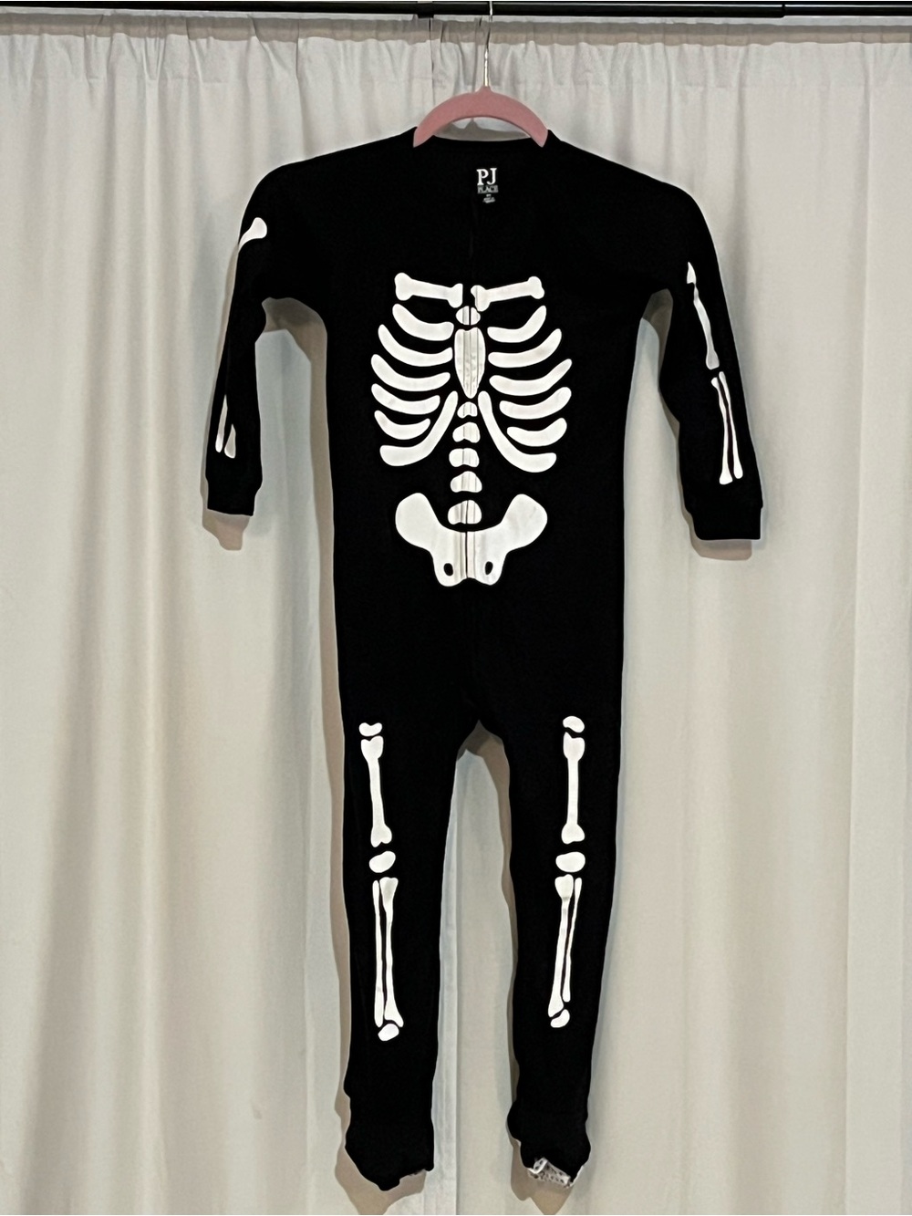 Place Black One-Piece Footie Pajamas with White Skeleton Print